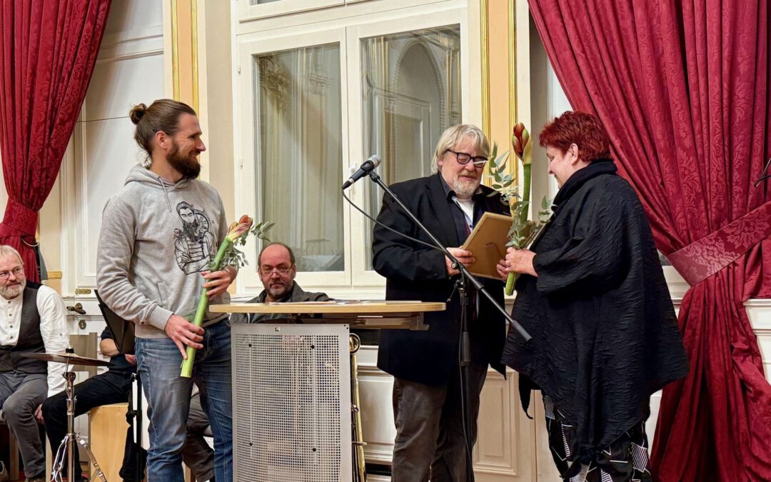 Babette Limp-Schelling, Geschäftsführerin Wohltat e.V. und Morten Hübbe, Redaktor, "Strohhalm", nehmen die Lobende Erwähnung für die Strohhalm-Redaktion entgegen. Bild: M. Nürnberger